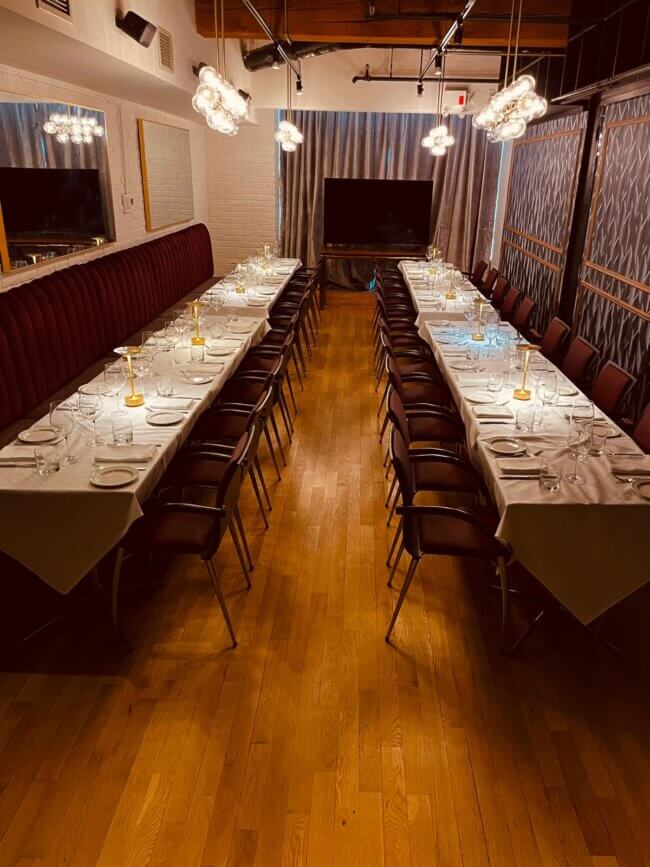 Long banquet-style private dining table set for dinner