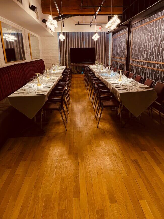 Long dining table elegantly set for a special event in a stylish restaurant