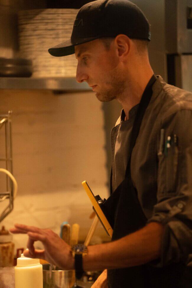 Bartender at Blu Ristorante expertly crafting a signature cocktail behind the bar