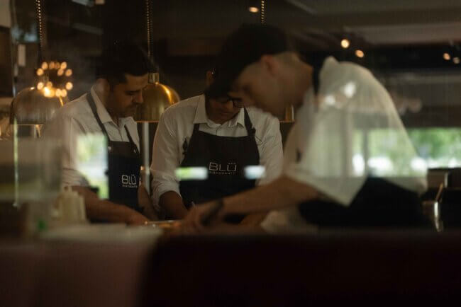 Close-up of a beautifully plated gourmet dish with fresh greens and sauce.
