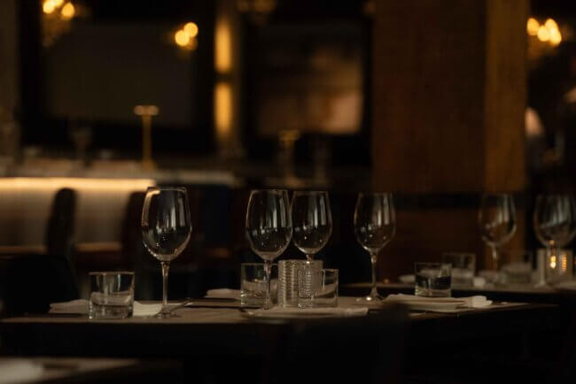 Diners enjoying an elegant evening meal at Blu Ristorante with warm, inviting lighting