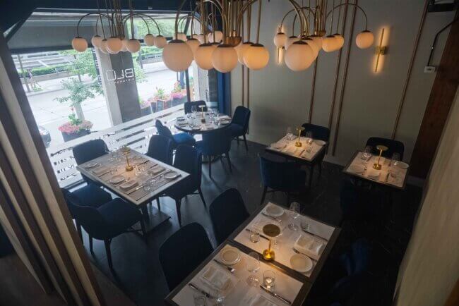 Overhead view of a stylish dining setup featuring round light fixtures.